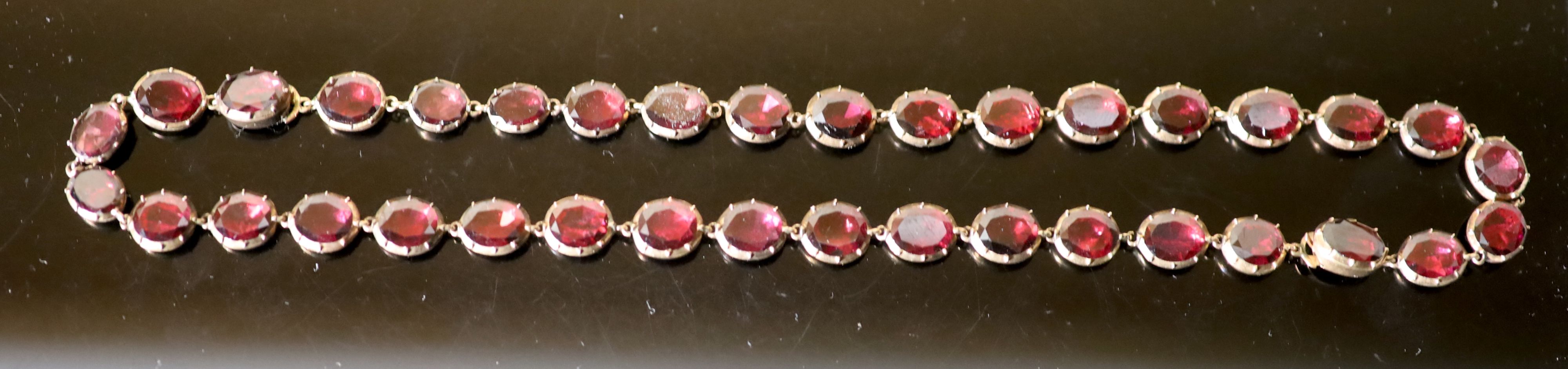 An early 19th century gold and garnet set necklace,